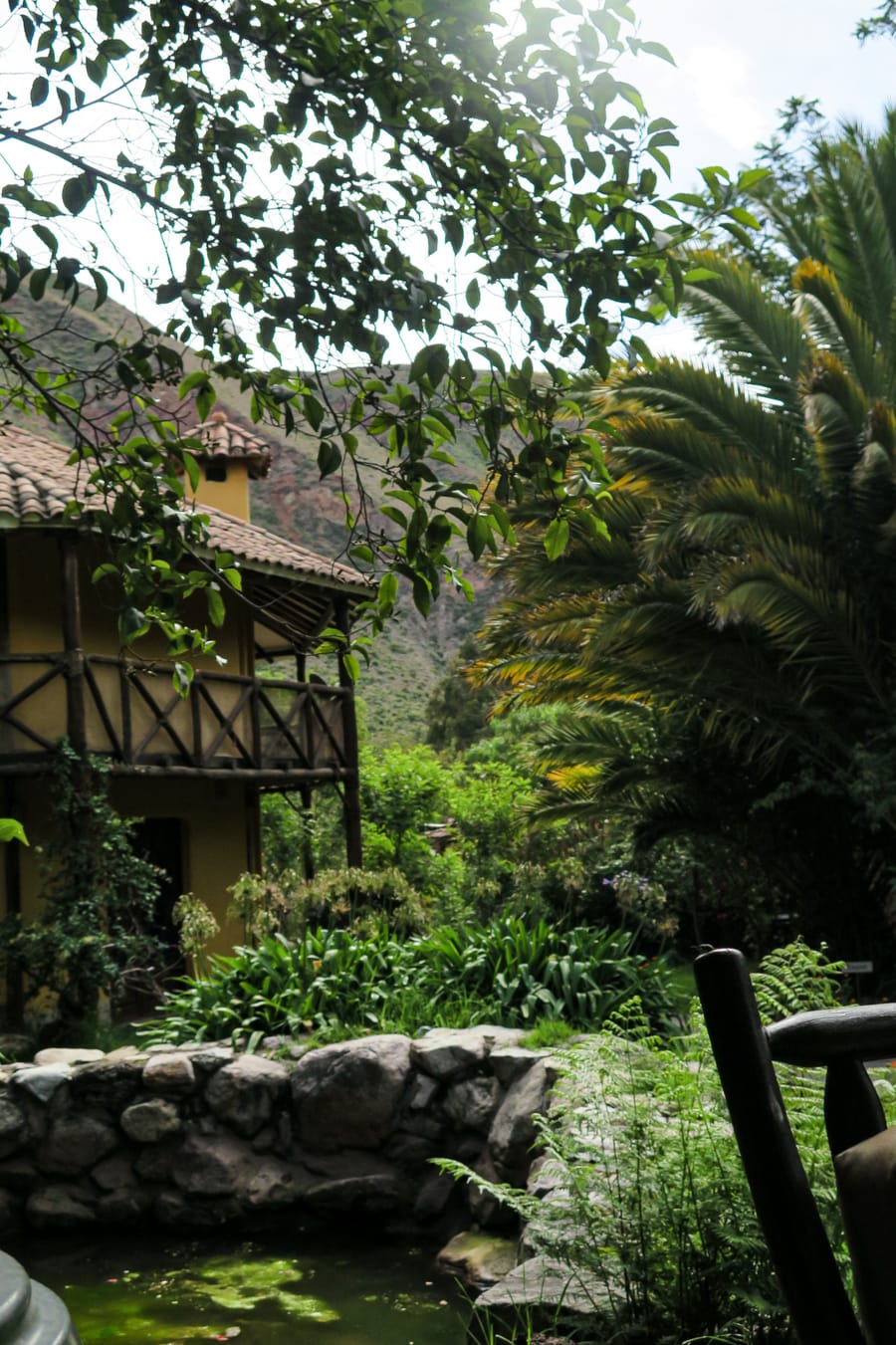 Balcón de madera con palmeras y la montaña al fondo